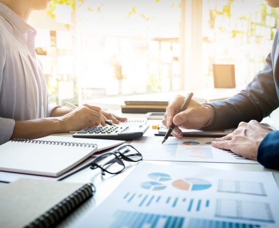 business man financial inspector and secretary making report, calculating or checking balance. Internal Revenue Service inspector checking document. Audit concept
