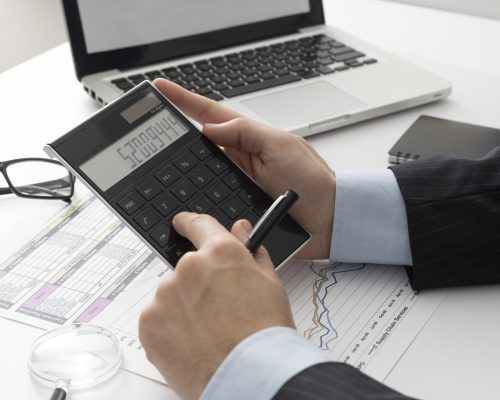 sideways-business-man-calculating-finance-numbers